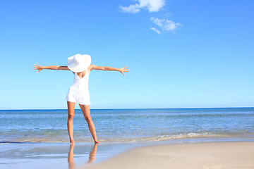 Image showing Young woman standing on a beach 