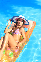 Image showing Young woman in the pool 