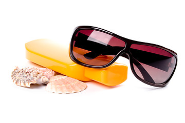 Image showing sunglasses, shells and lotion 