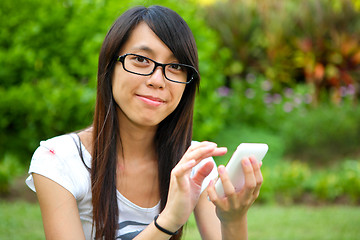 Image showing Beautiful young girl with pda outdoor