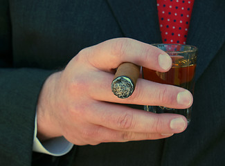 Image showing man holding a cigar and a shot of whiskey