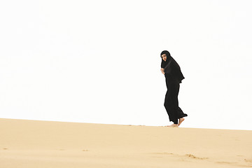 Image showing Woman walking by sand hill crest