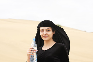 Image showing Smiling woman with water bottle