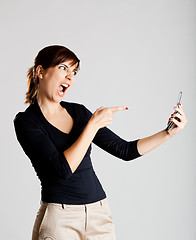 Image showing Unhappy woman at cellphone