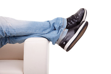 Image showing Detail, of some legs stretched on the couch