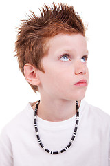 Image showing cute boy with a serious look, looking up