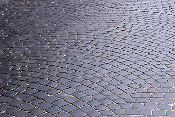 Image showing The road, covered with black stones