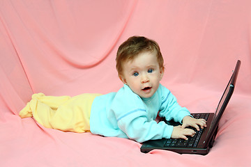 Image showing baby lying with laptop