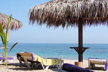 Image showing Sunchairs and umbrellas on Beach