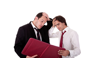 Image showing two businessmen talking about work, tired and worried, looking for a document