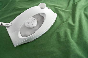 Image showing White iron on green cloth