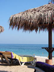 Image showing Sunchairs and umbrellas on Beach