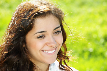Image showing Young smiling brunette looking sideways