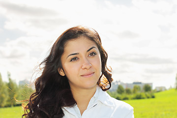 Image showing Young pensive brunette looking sideways