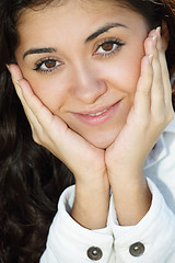 Image showing Young brunette leaning on palms