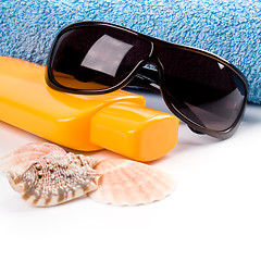 Image showing towel, shells, sunglasses and lotion 