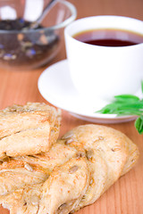 Image showing black tea with herbs and bread 
