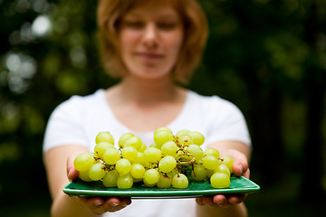 Image showing Girl holding green grapes