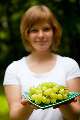 Image showing Girl holding green grapes