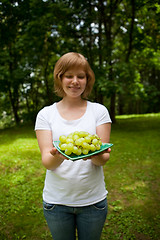 Image showing Girl holding green grapes