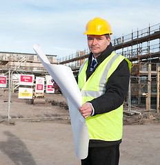 Image showing Architect on building site looks at camera