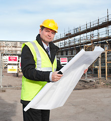 Image showing Architect on building site looks at camera