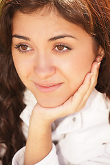 Image showing Young pensive brunette leaning on hand