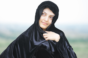 Image showing Woman in shawl looking up