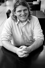 Image showing Man sitting at a table