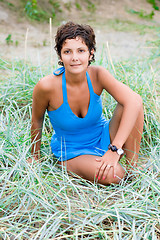 Image showing woman in blue sitting in a grass