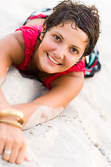 Image showing woman in red lying on a sand