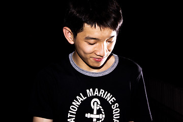 Image showing portrait of handsome smiley man over dark background 