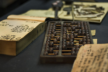 Image showing abacus and book on the table 