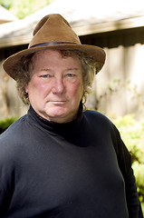 Image showing middle age senior man with fashionable hat in yard