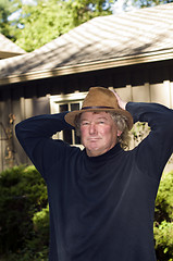 Image showing middle age senior man with fashionable hat in yard