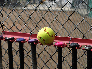 Image showing Yellow Softball and Bats
