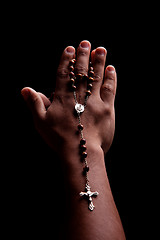 Image showing hands of a young latin men with a crucifix