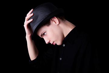 Image showing Young man wearing a hat over black background