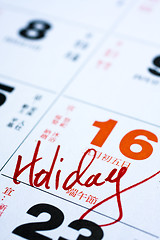 Image showing Hand writing holiday important date on calendar