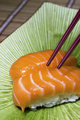 Image showing sushi and chopsticks on disk