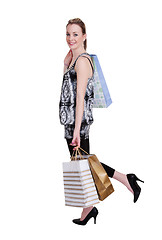Image showing young woman with shopping bags on white