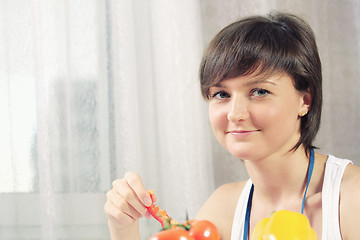 Image showing Housewife with slice of paprika