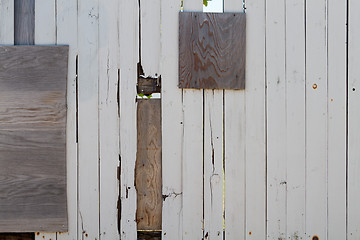 Image showing Heavily repaired wooden fence  