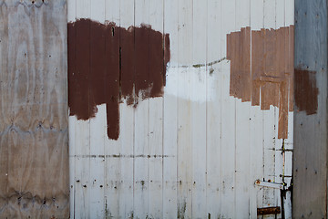 Image showing Repaired and painted wooden fence 