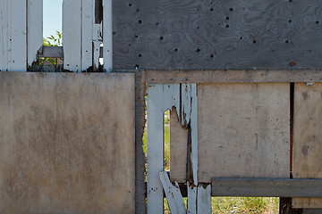 Image showing Very heavily repaired wooden fence  