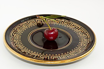 Image showing Cherry on a saucer