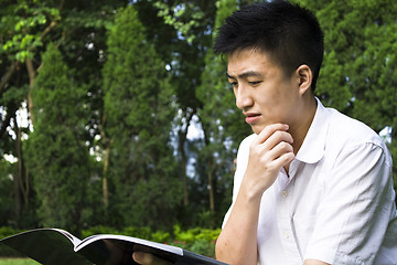 Image showing young student reading books at the school park