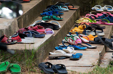 Image showing Plastic sandals on concrete stairs