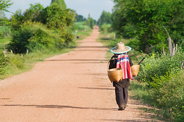 Image showing Farmer in Thailand walking home