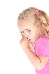 Image showing Little cute girl in studio eating candy